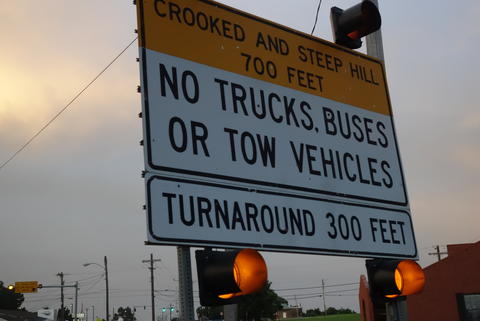 Caution sign barring trucks from the descent. 