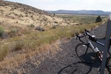 My bike in front of a long view of plains and mountains.